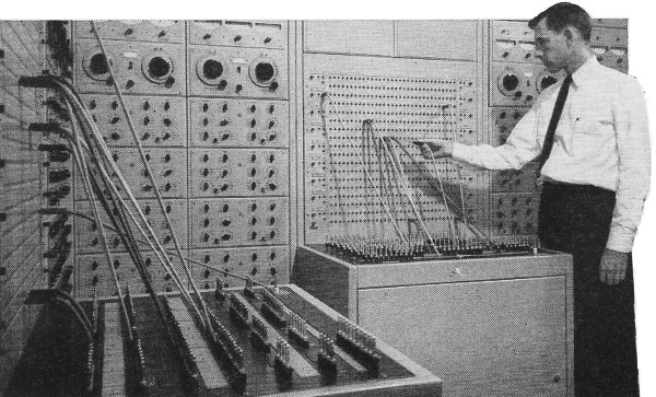 Someone moving around wires on an analog computer